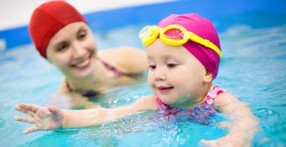 Mother and infant child swimming