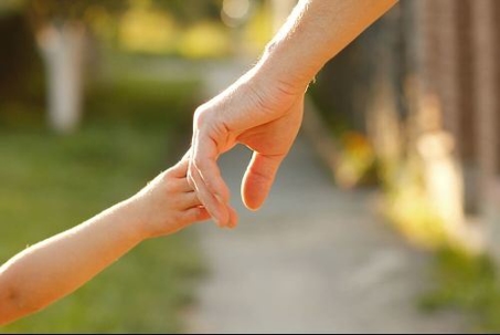 Parent holding childs hand
